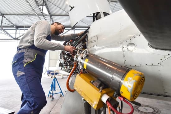 Aircraft mechanic checking a plane's engine