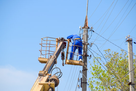 Man fixing the electrical line outdoors