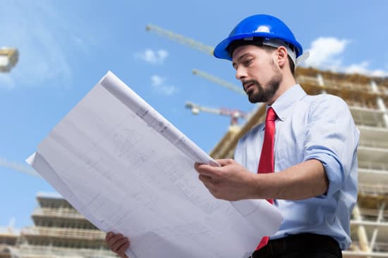 Construction manager checking the blueprint
