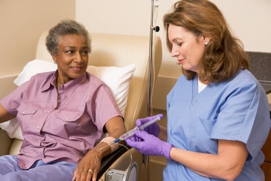 Nurse injecting a syringe to her patient