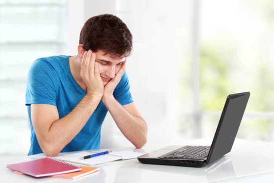 Tired of studying. young man covering his head while sitting. gesture of depression