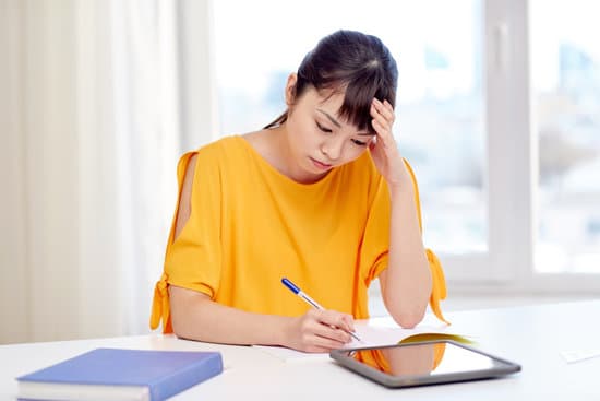 tired asian woman student with tablet pc at home