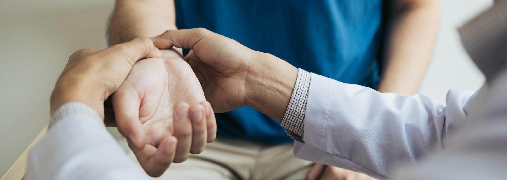 Doctor checking the pulse of his patient