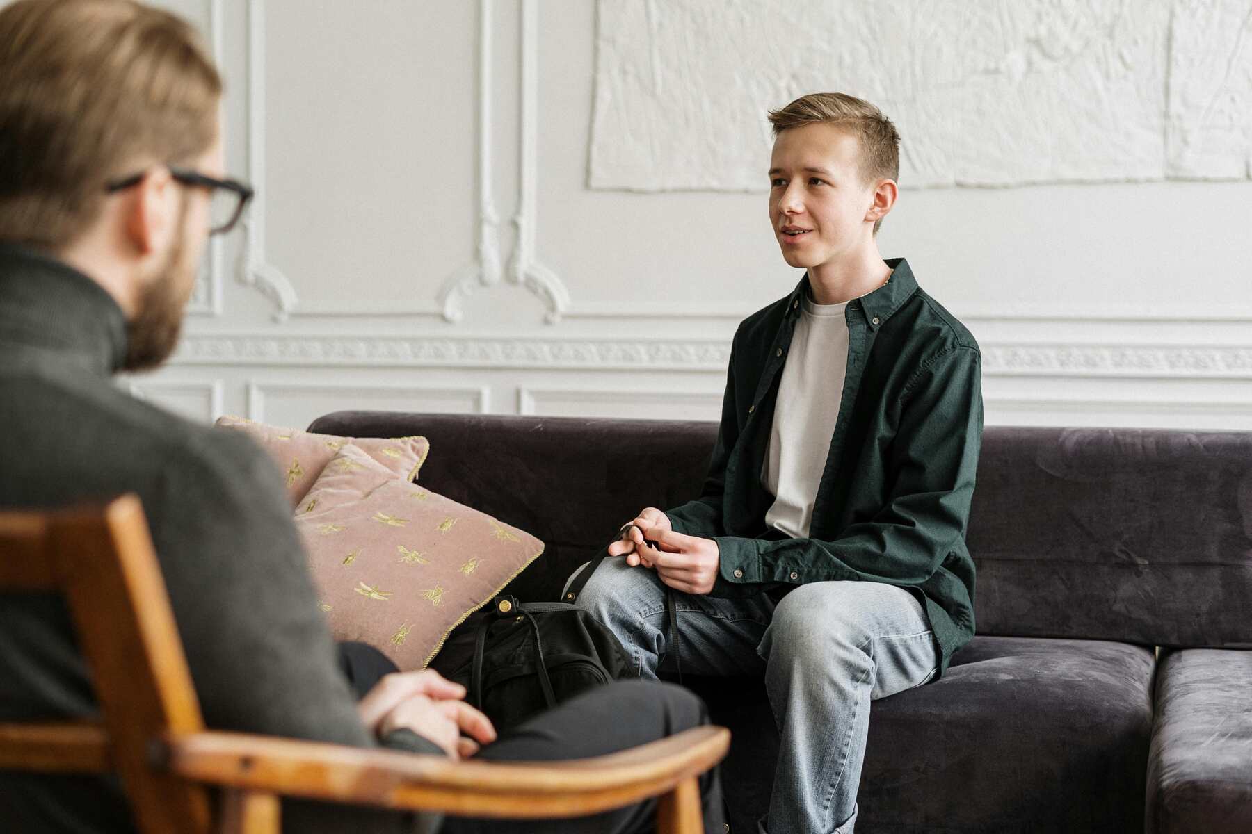 A teenager talking to a behavioral analyst