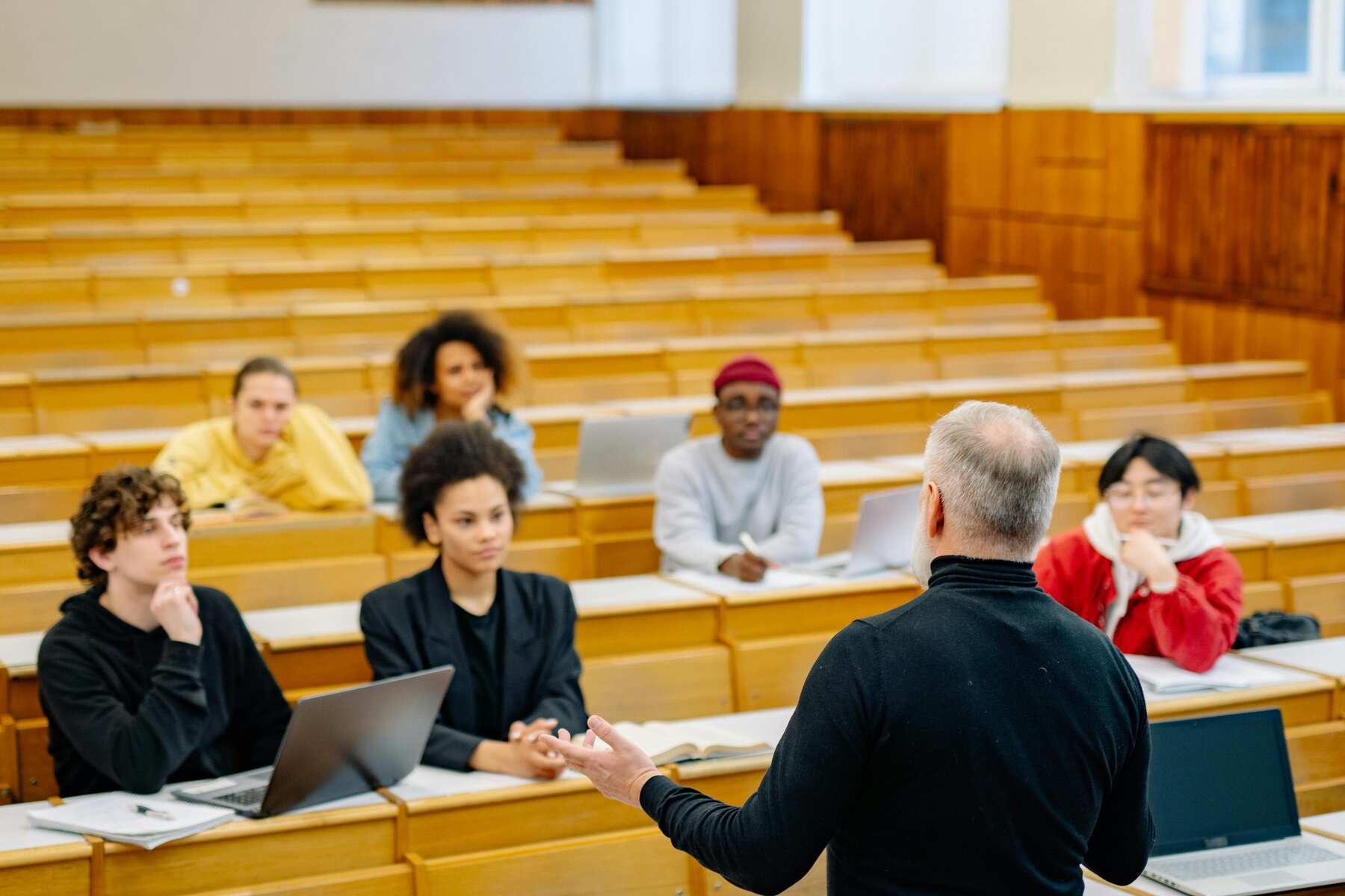 A class listening to their professor in front