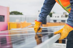 A solar panel being installed by a technician