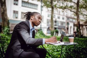 A college student studying on a table outside
