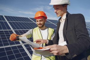 A solar engineer and a technician looking at a plan for their project