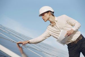 A solar consultant inspecting a newly-installed panel