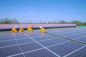 Technicians installing solar panels on a roof