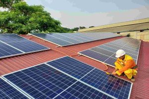 An installer setting up solar panels