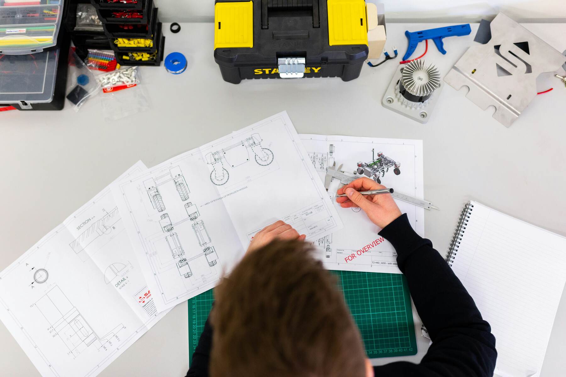 Man drawing diagrams on a table