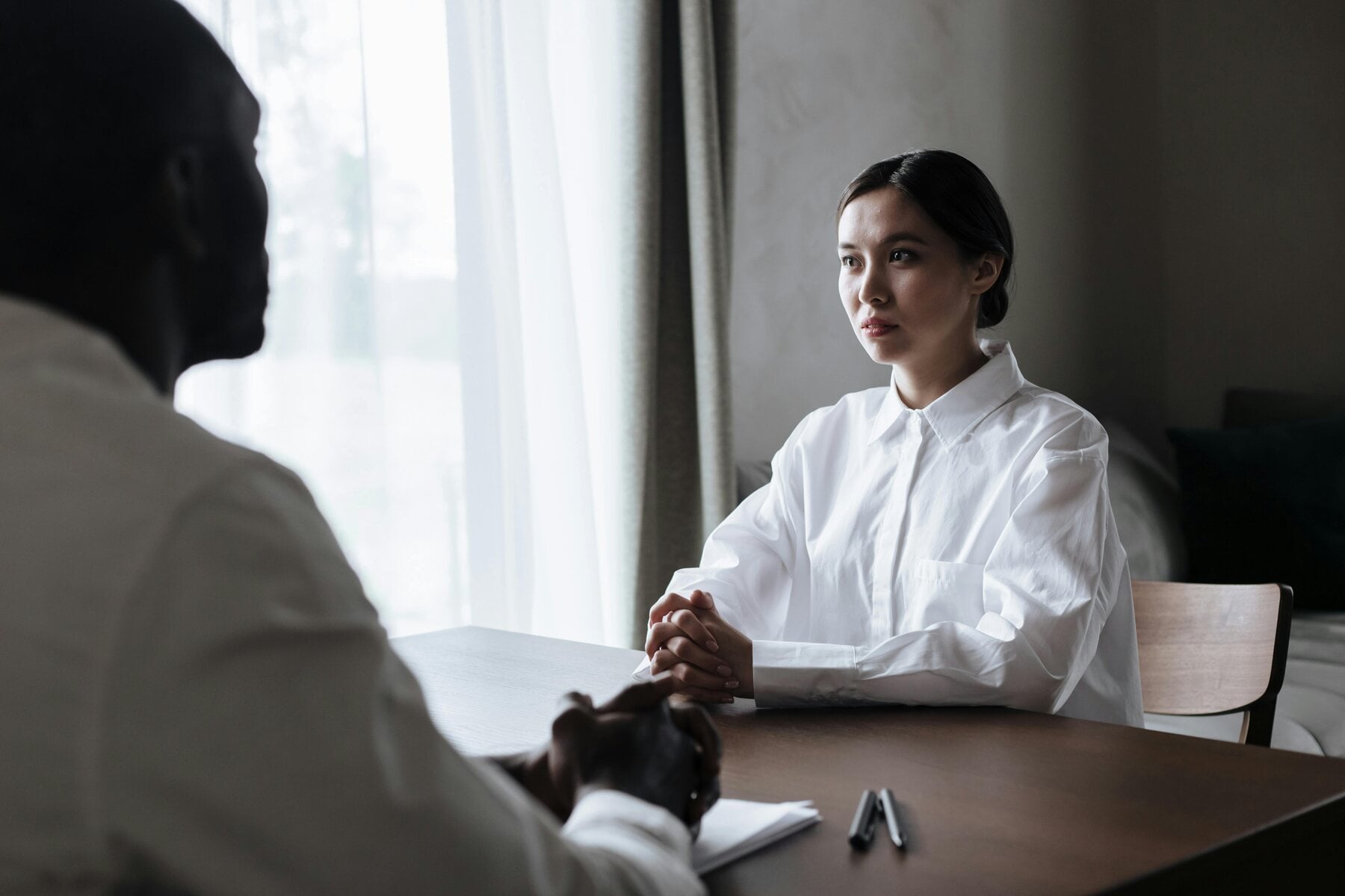 Woman listening intently to her patient during a session