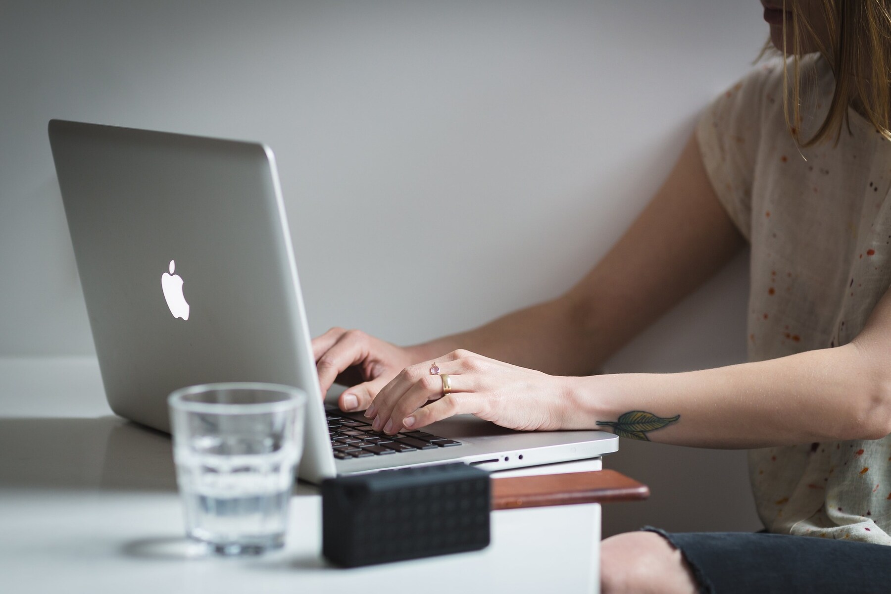 A woman focused on her laptop, typing away