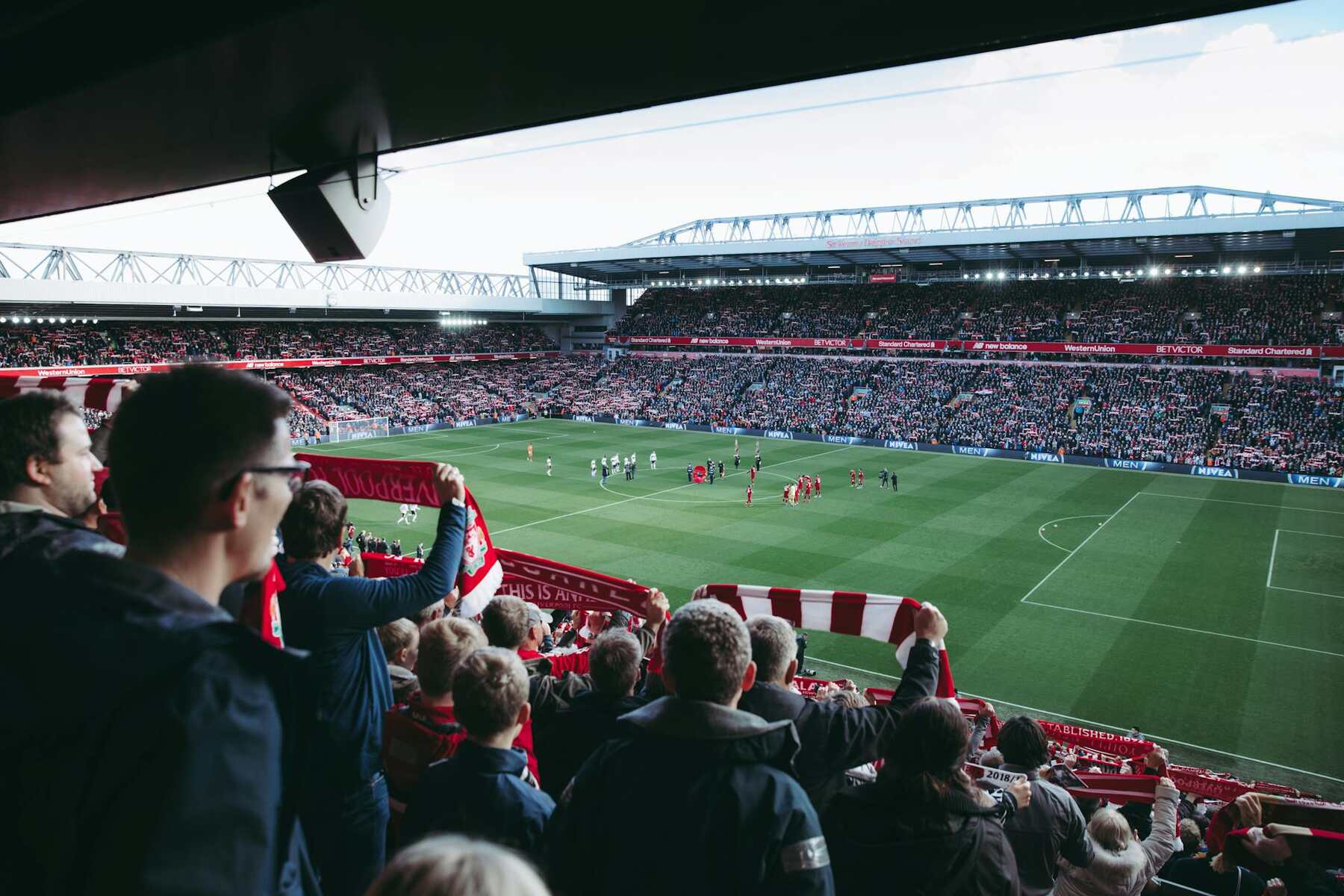 A group of spectators cheering at a soccer match