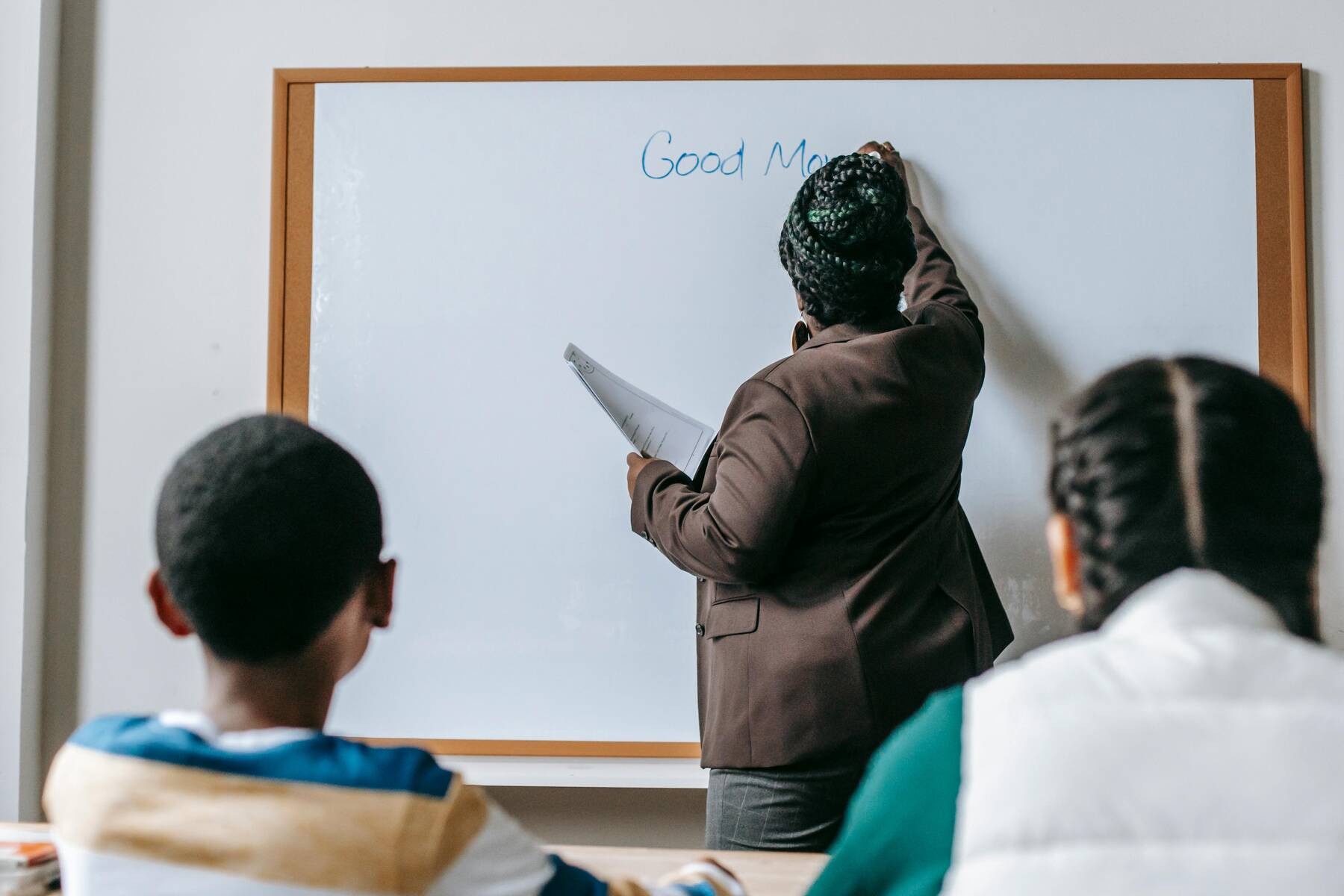 A teacher writing on the baord