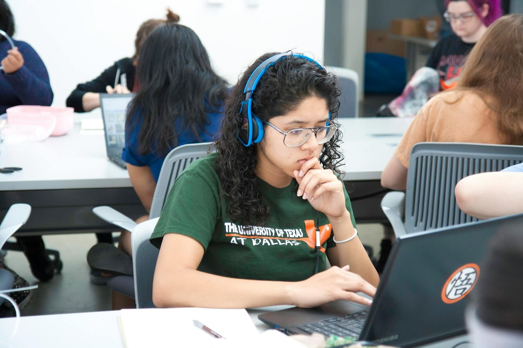 Young woman in headphones using a laptop