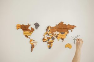 Person holding a toy plane while using a map