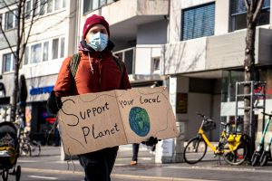 Man holding a pro environmental protest sign