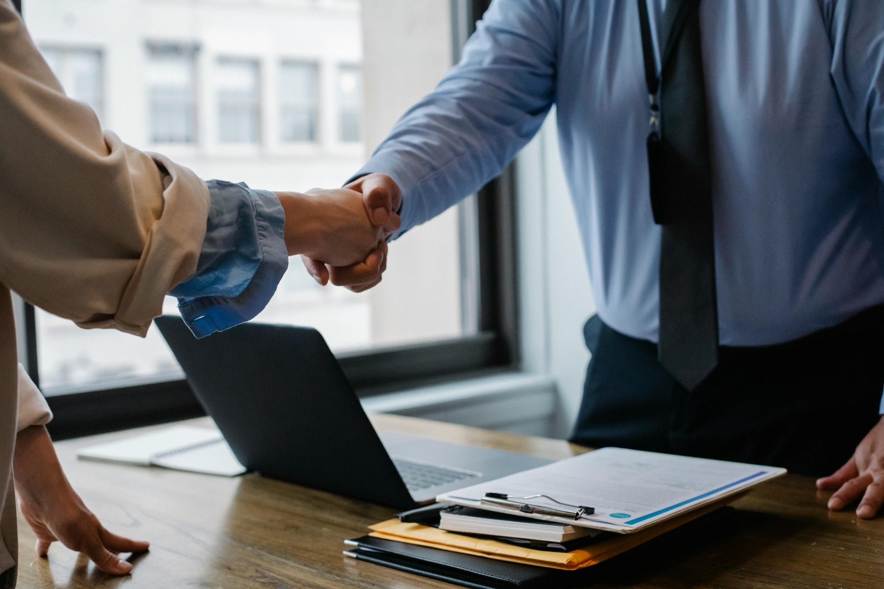 Two people shaking hands after a meeting